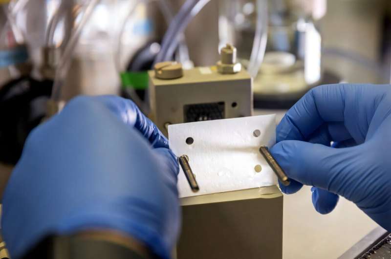 Jovan Kamcev, assistant professor of chemical engineering, places a membrane into an electrodialysis device. Credit: Marcin Szczepanski/Michigan Engineering Making desalination more eco-friendly: New membranes could help eliminate brine waste