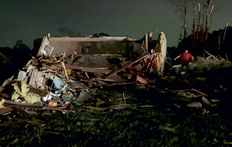 Local residents search through tornado damage in Laurel County near London, Kentucky. Local residents search through tornado damage in Laurel County near London, Kentucky