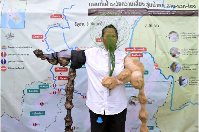 An activist dressed as a "mutated fish caught in a fishing net" takes part in a protest against alleged arsenic poisoning in the Kok river due to mining activities in Myanmar. An activist dressed as a "mutated fish caught in a fishing net" takes part in a protest against alleged arsenic poisoning in the Kok river due to mining activities in Myanmar