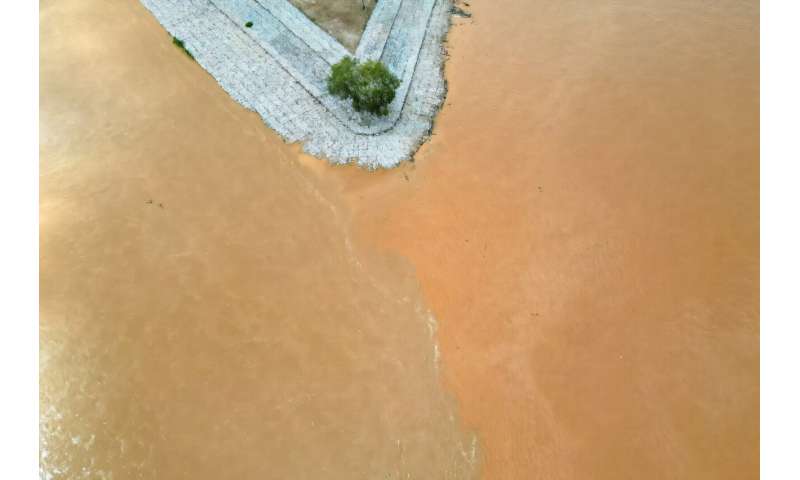 The Ruak river (L) meets with the Mekong River (R) in the Golden Triangle region, as pictured from northern Thailand's Chiang Rai province