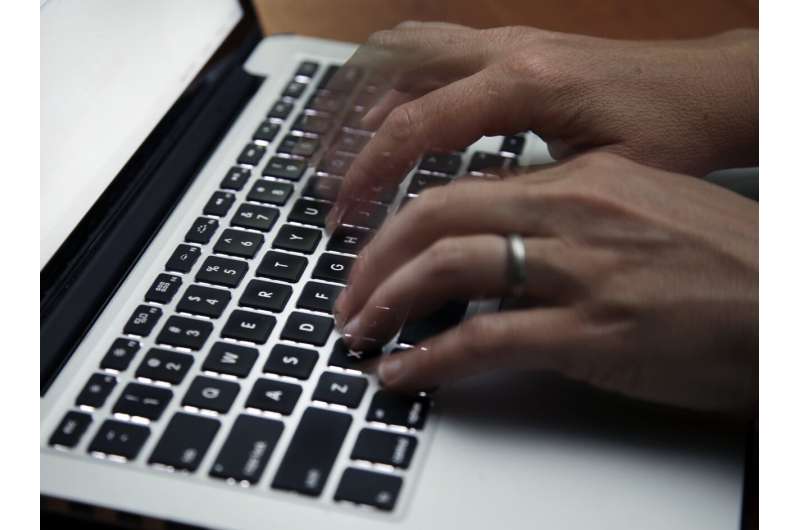 This June 19, 2017 file photo shows a person working on a laptop in North Andover, Mass. Credit: AP Photo/Elise Amendola, File Billions of login credentials have been leaked online, Cybernews researchers say