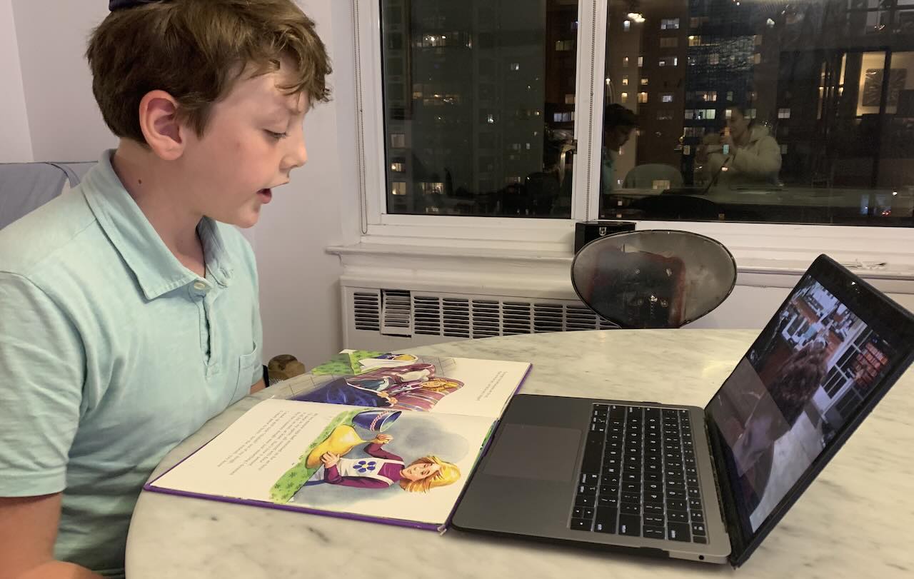 Asher reading to children in 2020