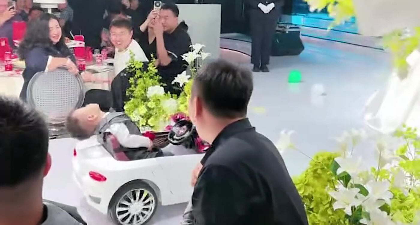 Ring bearer asleep in toy car