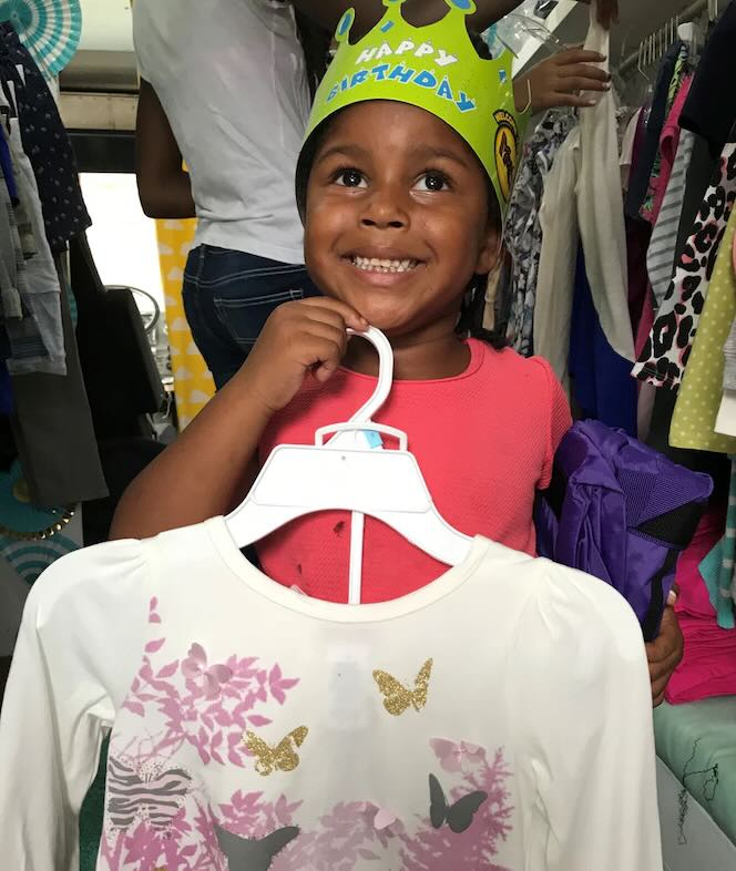 A girl receives a new shirt