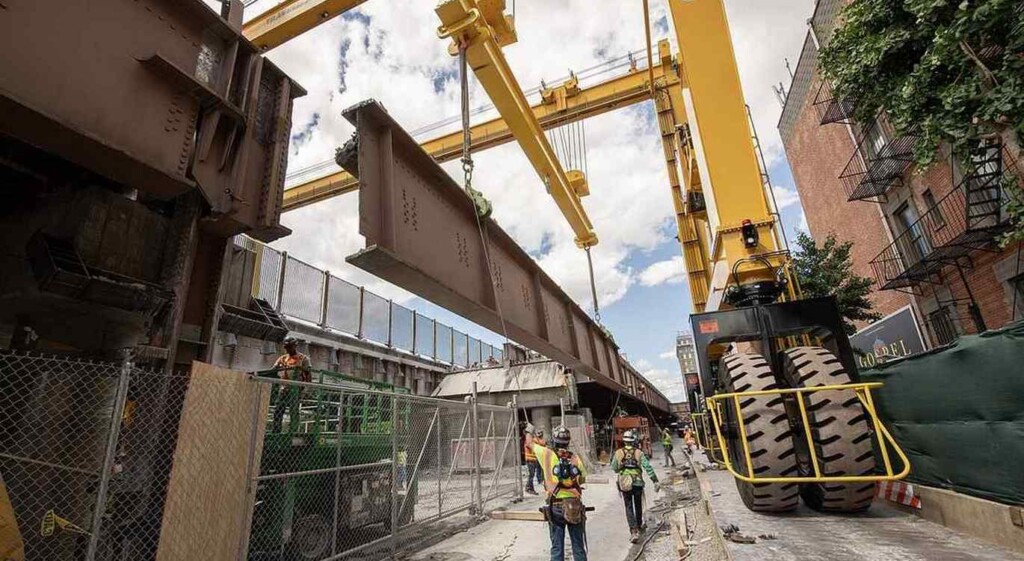Construction workers using hydraulic gantry
